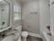 A modern bathroom featuring a granite countertop, new fixtures, and shower-tub combination at 650 Lake Forest Ct, Roswell, GA 30076