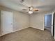 Bedroom featuring neutral walls, carpet flooring, and 2 closets at 650 Lake Forest Ct, Roswell, GA 30076