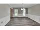 This dining room features wainscotting, new floors, a modern light fixture and views of the front yard at 650 Lake Forest Ct, Roswell, GA 30076