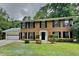 Charming two-story brick home featuring a well-manicured lawn and a two-car garage, complete with traditional black shutters at 650 Lake Forest Ct, Roswell, GA 30076