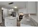 This updated kitchen features stainless steel appliances, granite countertops, a center island, and modern lighting at 650 Lake Forest Ct, Roswell, GA 30076