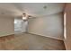 The bright main bedroom suite features neutral walls, new carpet, a ceiling fan, and an ensuite bathroom at 650 Lake Forest Ct, Roswell, GA 30076