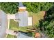 Birds eye view shows a backyard with a large wooden deck, manicured lawns, and mature trees at 7000 Foxberry Ln, Roswell, GA 30075