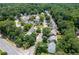 A neighborhood of closely spaced houses with lush green trees surrounding the homes at 7000 Foxberry Ln, Roswell, GA 30075