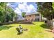 Large backyard with expansive lawn, a deck, and a wooden privacy fence for outdoor living at 7000 Foxberry Ln, Roswell, GA 30075