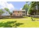 Expansive backyard featuring a deck, lush green lawn, and a wooden privacy fence at 7000 Foxberry Ln, Roswell, GA 30075