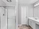 A bright bathroom with a glass enclosed shower and a double sink vanity at 7000 Foxberry Ln, Roswell, GA 30075