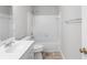 Clean bathroom featuring a tub-shower combo with white tile surround and neutral flooring at 7000 Foxberry Ln, Roswell, GA 30075