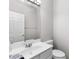 Well-lit half bathroom features a vanity with modern fixtures at 7000 Foxberry Ln, Roswell, GA 30075