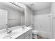 Bright bathroom features a double sink vanity with tub-shower combo and tile flooring at 7000 Foxberry Ln, Roswell, GA 30075