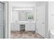Bright bathroom with a double vanity, cabinets, large mirror and modern lighting at 7000 Foxberry Ln, Roswell, GA 30075
