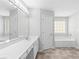 Bright bathroom featuring double vanity, soaking tub and large mirror with modern lighting at 7000 Foxberry Ln, Roswell, GA 30075