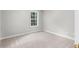 An empty bedroom with a large window at 7000 Foxberry Ln, Roswell, GA 30075