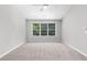 Bright bedroom with carpeted floor, ceiling fan, and large windows at 7000 Foxberry Ln, Roswell, GA 30075