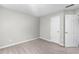 Empty bedroom with neutral carpet, paint, and two doors at 7000 Foxberry Ln, Roswell, GA 30075