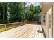 Spacious wooden deck perfect for outdoor gatherings, with lush greenery and home siding at 7000 Foxberry Ln, Roswell, GA 30075