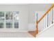 Open entryway with wood floors, a staircase, wainscoting, and large windows at 7000 Foxberry Ln, Roswell, GA 30075