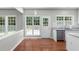 Eat-in kitchen with backyard access, stainless steel appliances, granite countertops, and white cabinets at 7000 Foxberry Ln, Roswell, GA 30075