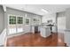 Spacious kitchen featuring stainless appliances, white cabinets, granite countertops, and backyard views at 7000 Foxberry Ln, Roswell, GA 30075