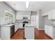 Updated kitchen with stainless steel appliances, white cabinets, and a center island, perfect for entertaining at 7000 Foxberry Ln, Roswell, GA 30075