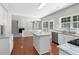 Bright kitchen with white cabinets, granite countertops, island, and stainless steel appliances at 7000 Foxberry Ln, Roswell, GA 30075