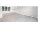 Spacious living room with plush carpet, wainscoting, and large windows for natural light at 7000 Foxberry Ln, Roswell, GA 30075