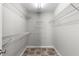 Empty walk-in closet featuring shelving for organization at 7000 Foxberry Ln, Roswell, GA 30075
