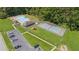 Aerial view of community amenities including a pool, tennis court, playground, and parking at 120 Timbervalley Ln, Lawrenceville, GA 30043