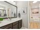 Bathroom with brown cabinets, a large framed mirror, and a separate soaking tub at 120 Timbervalley Ln, Lawrenceville, GA 30043