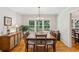 Dining room with windows, chandelier, wood floors, and large table with seating at 120 Timbervalley Ln, Lawrenceville, GA 30043
