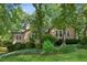 Charming home with lush landscaping and mature trees offering shade and privacy at 120 Timbervalley Ln, Lawrenceville, GA 30043