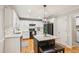 Bright kitchen featuring an island, white cabinets, granite counters, subway tile backsplash, and stainless steel appliances at 120 Timbervalley Ln, Lawrenceville, GA 30043