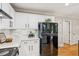 Kitchen with white cabinets, black appliances, and subway tile backsplash at 120 Timbervalley Ln, Lawrenceville, GA 30043