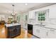 Bright kitchen featuring an island, white cabinets, granite counters, subway tile backsplash, and stainless steel appliances at 120 Timbervalley Ln, Lawrenceville, GA 30043