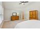 Spacious primary bedroom with a large dresser, carpeting and a ceiling fan at 120 Timbervalley Ln, Lawrenceville, GA 30043