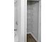 Linen closet with multiple shelves, offering generous storage next to the tub and shower area at 2438 Suwanee Pointe Dr, Lawrenceville, GA 30043