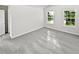 Bright bedroom with natural light, featuring two windows and neutral-toned walls and carpet at 2438 Suwanee Pointe Dr, Lawrenceville, GA 30043