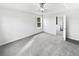 A bright, spacious bedroom featuring plush carpet, a tray ceiling with fan, and ample natural light at 2438 Suwanee Pointe Dr, Lawrenceville, GA 30043