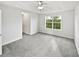 A bright, spacious bedroom featuring plush carpet, a tray ceiling with fan, and ample natural light at 2438 Suwanee Pointe Dr, Lawrenceville, GA 30043