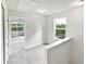 Well-lit hallway with a window and open view of a bedroom, showcasing the home's spacious layout at 2438 Suwanee Pointe Dr, Lawrenceville, GA 30043