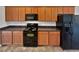 Functional kitchen with black appliances, ample counter space, and wooden cabinets at 2438 Suwanee Pointe Dr, Lawrenceville, GA 30043