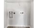 Functional laundry room with essential hookups and a shelf, ready for washer and dryer installations at 2438 Suwanee Pointe Dr, Lawrenceville, GA 30043