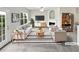 Bright, staged living room features fireplace, neutral walls, and stylish furniture at 2438 Suwanee Pointe Dr, Lawrenceville, GA 30043