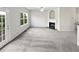 Open living room with fireplace, neutral walls, and lots of natural light at 2438 Suwanee Pointe Dr, Lawrenceville, GA 30043