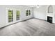 Spacious living room with plush gray carpeting, a fireplace, and plenty of natural light at 2438 Suwanee Pointe Dr, Lawrenceville, GA 30043