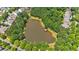 Scenic aerial shot of a serene pond surrounded by trees within a residential community at 3278 Shakerley Park, Douglasville, GA 30135