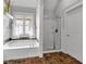 Bathroom featuring a soaking tub with curtains, a glass shower, and beautiful tiled floors at 3278 Shakerley Park, Douglasville, GA 30135