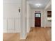Bright foyer features hardwood floors, white trim, and a shiplap accent wall with a dark wood front door at 3278 Shakerley Park, Douglasville, GA 30135