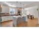 Bright, modern kitchen features a large center island with stone accents and an adjacent dining area at 3278 Shakerley Park, Douglasville, GA 30135