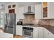 Spacious kitchen featuring stainless steel appliances, a brick backsplash, and ample cabinet space at 3278 Shakerley Park, Douglasville, GA 30135